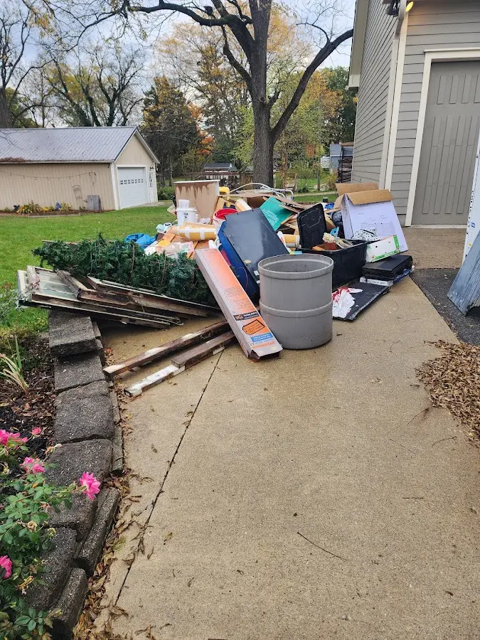 Dumpster being loaded with debris for 3 Yard Dumpster Rental in Forney